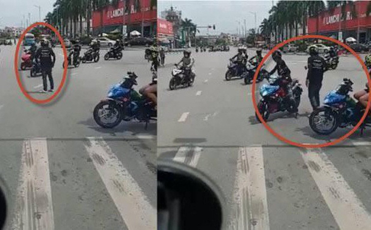 Hình ảnh nam thanh niên chặn đường cho đoàn phượt thủ chạy qua. (Ảnh: Cắt từ clip).