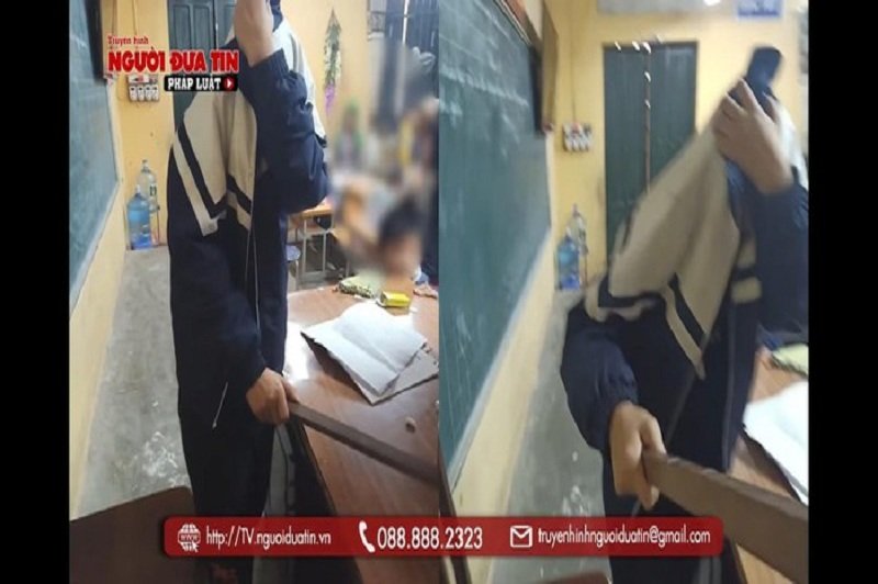 Học sinh trùm mặt cầm thước đánh lại cô giáo. (Ảnh cắt từ clip Truyền hình Người đưa tin).