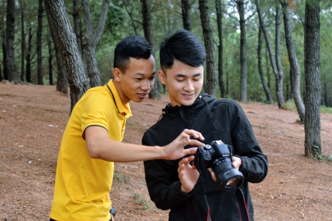 Hai bạn trẻ chụp ảnh cho nhau.