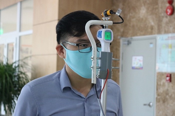 Đo thân nhiệt với chiếc máy đo thân nhiệt tự động trước khi vào làm việc.