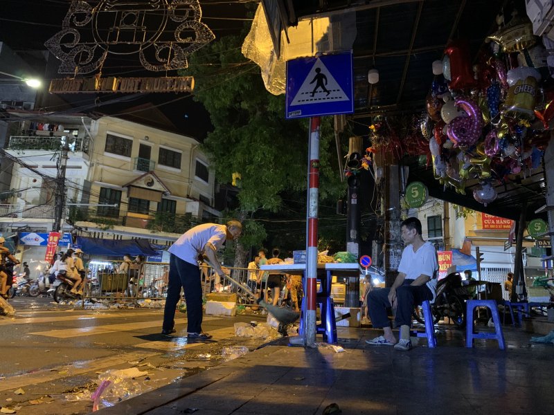 Một tiểu thương tranh thủ dọn dẹp trước khi dọn hàng.
